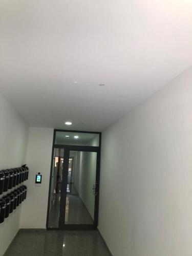 a hallway with a glass door in a building at Brand new apartment 2 mins from Seafront in St Paul's Bay