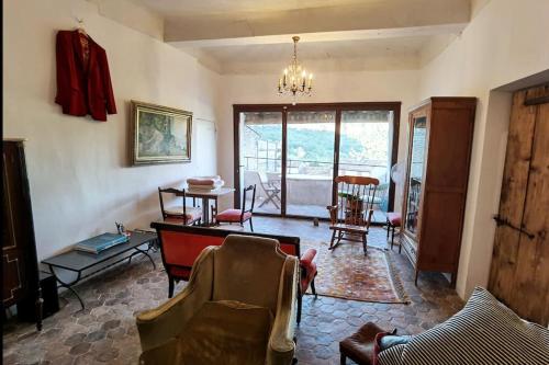 a living room with chairs and a table and a dining room at Spacious stylish Provencal house with terrace in Saignon