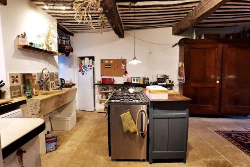 a kitchen with a stove top oven in a room at Spacious stylish Provencal house with terrace in Saignon