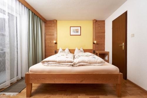 a bedroom with a bed with white pillows on it at Aktivurlaub Morandell in Sölden