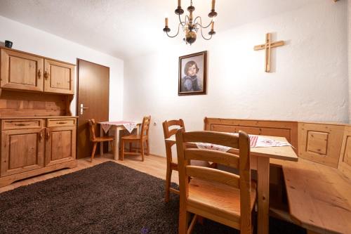 a dining room with a table and a cross on the wall at Aktivurlaub Morandell in Sölden