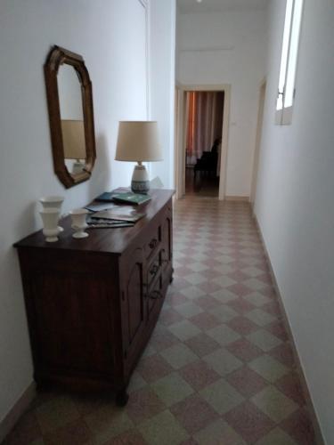 a room with a dresser with a mirror and a lamp at Don Aniello Alloggio Turistico in Sulmona