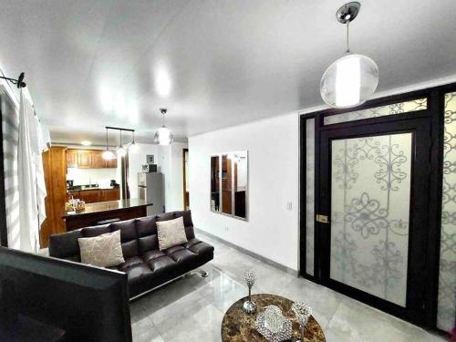 a living room with a couch and a table at Airport SJO Residence - Edward & Familia Inn in Alajuela City