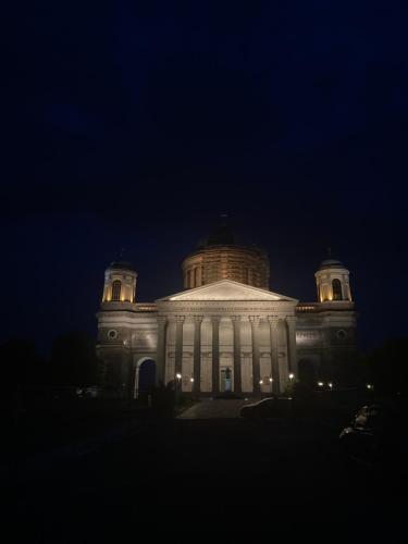 a large white building with lights on it at night at Apartman-Donau Tát in Tát