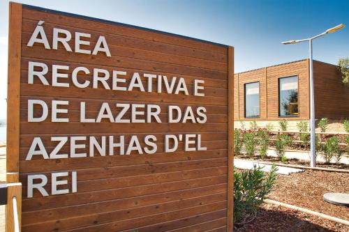 a sign on a wooden fence in front of a building at Monte Alecrim in Alandroal