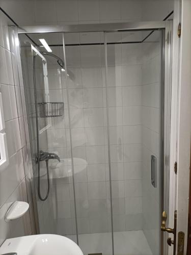 a glass shower in a bathroom with a sink at Disan 3B in Portonovo