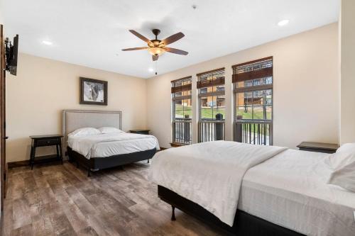 a bedroom with two beds and a ceiling fan at Beautiful Branson Lodge Close to All the Action in Branson