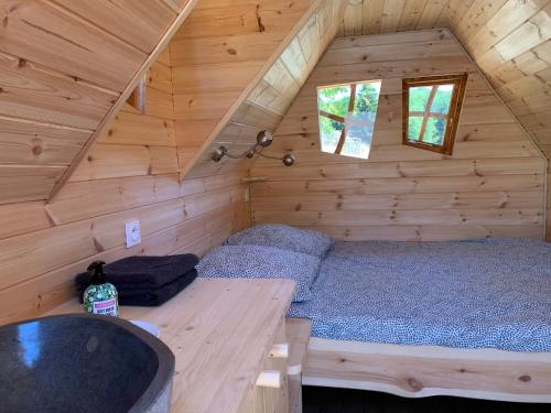 a bedroom with a bed in a log cabin at Insolite avec piscine Au Bonheur Comtois in Ronchamp