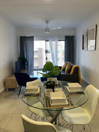 a dining table and chairs in a living room at Villa 86, Ballito in Ballito