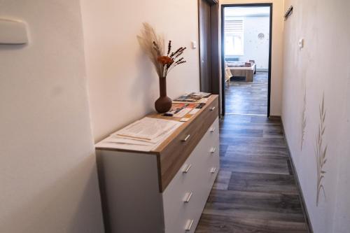 Habitación con escritorio y jarrón. en Apartmány Nežárka a privátní wellness, en Jindřichův Hradec