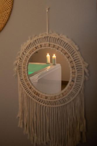 a mirror with two candles on a table at Spa, Love & Relax in Périgueux