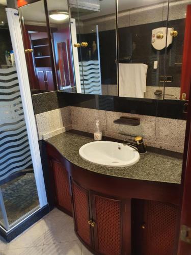 Nogalera Sea&Sun Apartment في توريمولينوس: حمام مع حوض ومرآة كبيرة