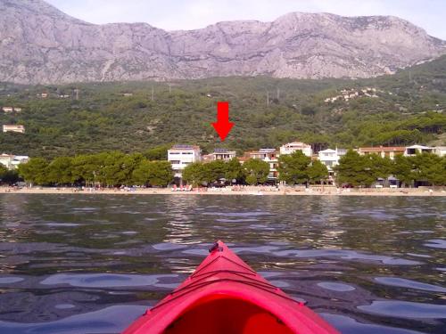 a view from the back of a kayak on a body of water at Apartments JD in Tučepi