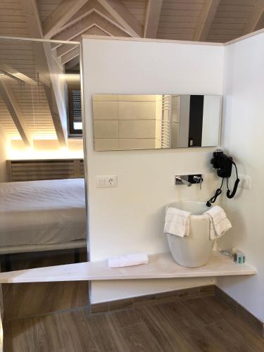 a bathroom with a sink with a mirror and a bed at HOTEL MONTE PERDIDO in Bielsa