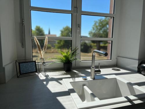 a kitchen counter with a sink and a window at Alte Schule Seinsfeld in Seinsfeld