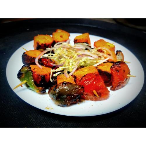 a plate of food with vegetables on a table at Bajoon homestay in Bhīm Tāl