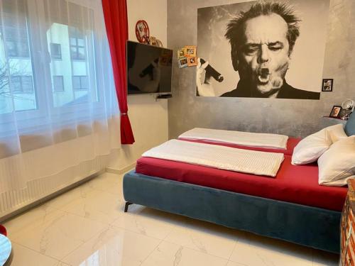 a bed in a room with a poster of a man at Hotel Karthäuser Hof in Flörsheim