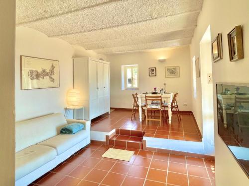 a living room with a couch and a table at Aria di Collina - Isola d'Elba in Porto Azzurro
