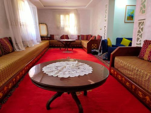 a living room with couches and a coffee table at Casa Tligui in Asilah