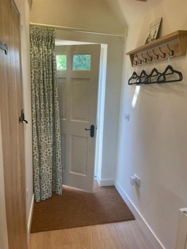 a hallway with a door with a curtain and a window at Garden Studio in Newbury