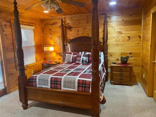 a bedroom with a bed in a log cabin at Hibernation Hideaway in Blairsville
