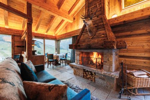 a living room filled with furniture and a fire place at Park Chalet Village in Livigno