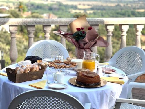 a table with food and bread on a balcony at Paradise in Aldea del Fresno