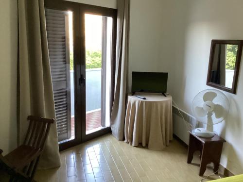 a room with a table with a laptop on it at Miradouro da Serra in Monchique