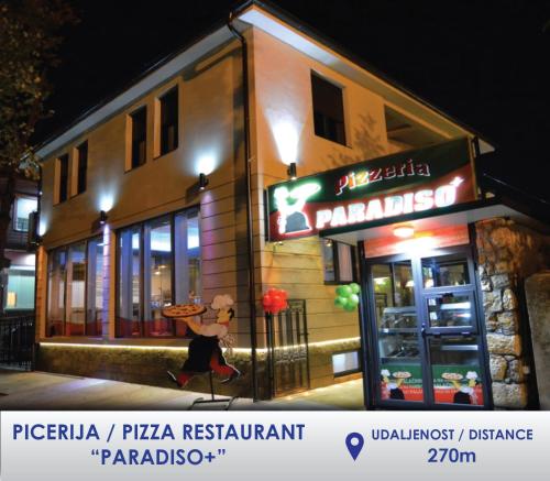 a pizza restaurant with a sign on the side of a building at Apartman Stevan in Pirot