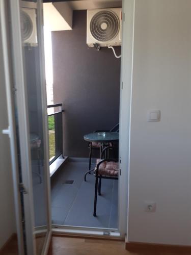 a door leading into a room with a table and a window at Apartman kod Brke 20 A Bulevar Vojvode Živojina Mišiča in Banja Luka