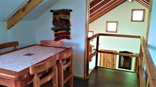 a dining room with a table and a mirror at Casa Bosque Paraíso in Pucón