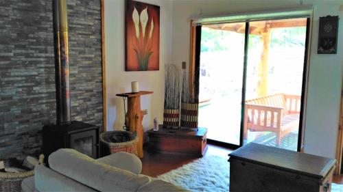 a living room with a couch and a fireplace at Casa Bosque Paraíso in Pucón