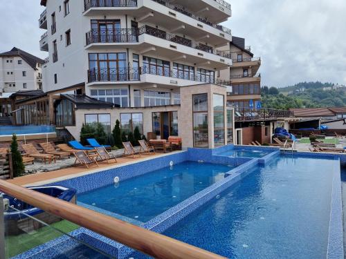 a large swimming pool in front of a building at Apartman Sky Milmari L20 in Kopaonik