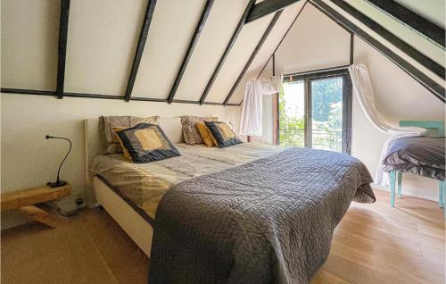 a bedroom with a bed and a large window at 1 Bedroom Beautiful Home In Boekelo in Boekelo