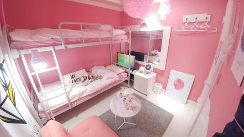 a small room with two bunk beds and a desk at Spring Light in Seoul