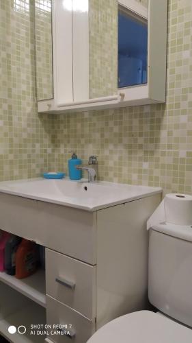 a bathroom with a white sink and a toilet at Studio Almudena in Torrevieja