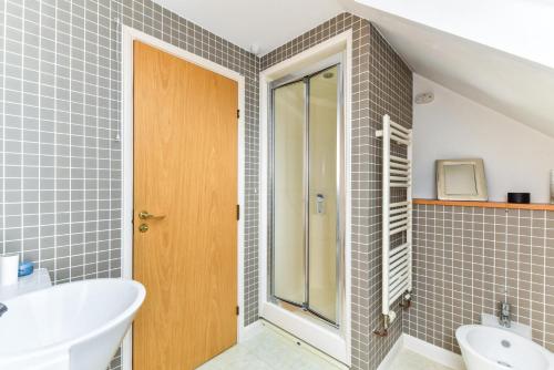 a bathroom with a shower and a sink and a toilet at Modern 4 bedroom Terraced House by the Thames in London
