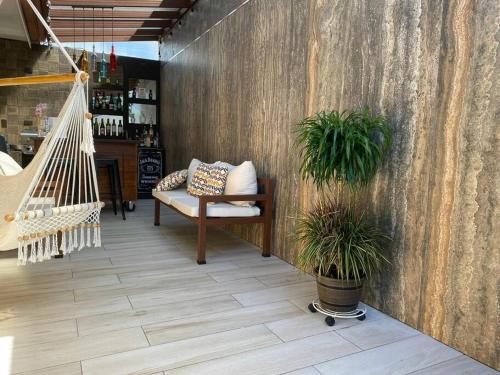 a room with a hammock and two potted plants at Airport SJO Residence - Edward & Familia Inn in Alajuela City