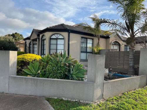 a house with a fence and plants in front of it at Affordable getaways in Caroline Springs