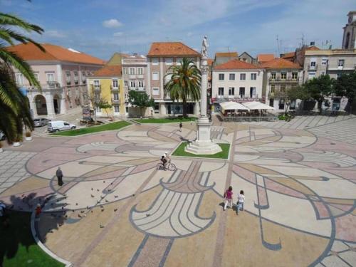 a group of people walking around a large plaza at Concha Setúbal Miradouro in Setúbal