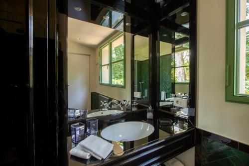 a bathroom with two sinks and a large mirror at The Greenhouse Luxury Villa on Lake Como in Como