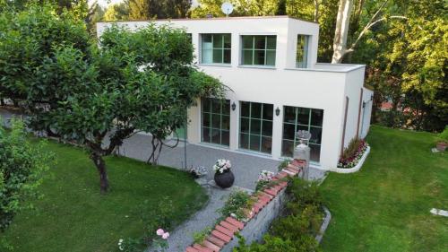 an aerial view of a white house with a yard at The Greenhouse Luxury Villa on Lake Como in Como