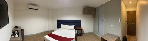 a small room with a bed and a tv at Anex Hotel near US Embassy in Manila