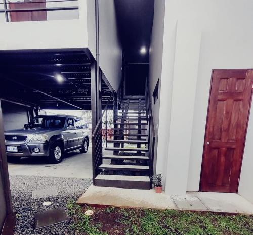 une voiture garée dans un garage à côté d'un escalier dans l'établissement Villas del General, à San Isidro de El General