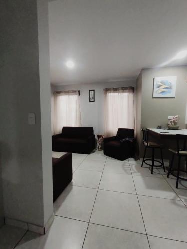 a living room with a couch and a dining room table at Villas del General in San Isidro