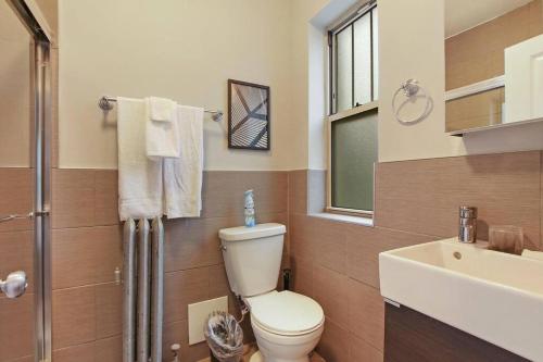 a bathroom with a toilet and a sink at Stylish Studio Apartment in Portage Park - Pensacola 2N in Chicago