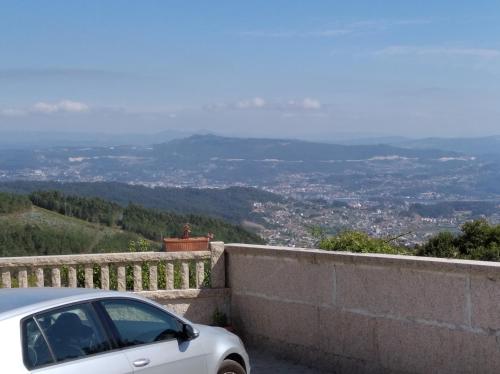 a white car parked on a wall with a view at Casa Elvira, terraza con fabulosas vistas in Pontevedra