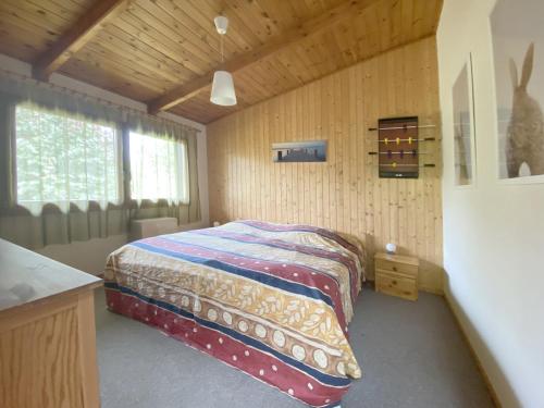 a bedroom with a bed in a wooden room at Ferienhaus, Suhlendorf in Suhlendorf