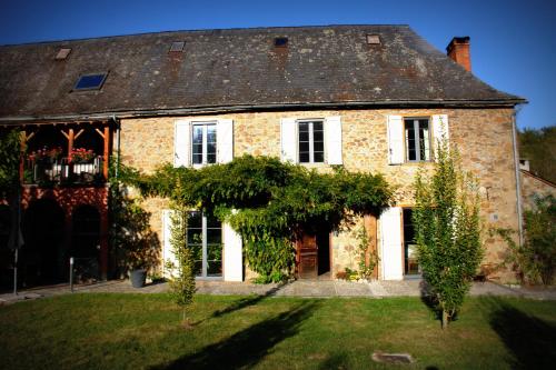 a large brick house with trees in front of it at Bed In Bellongue in Aucazein