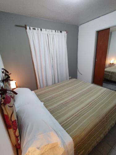 1 dormitorio con 1 cama grande y ventana en Shaddai alojamientos en Salta